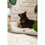 Cream-colored corduroy legowisko milano rose with soft ribbed texture and small brown leather tag for dogs